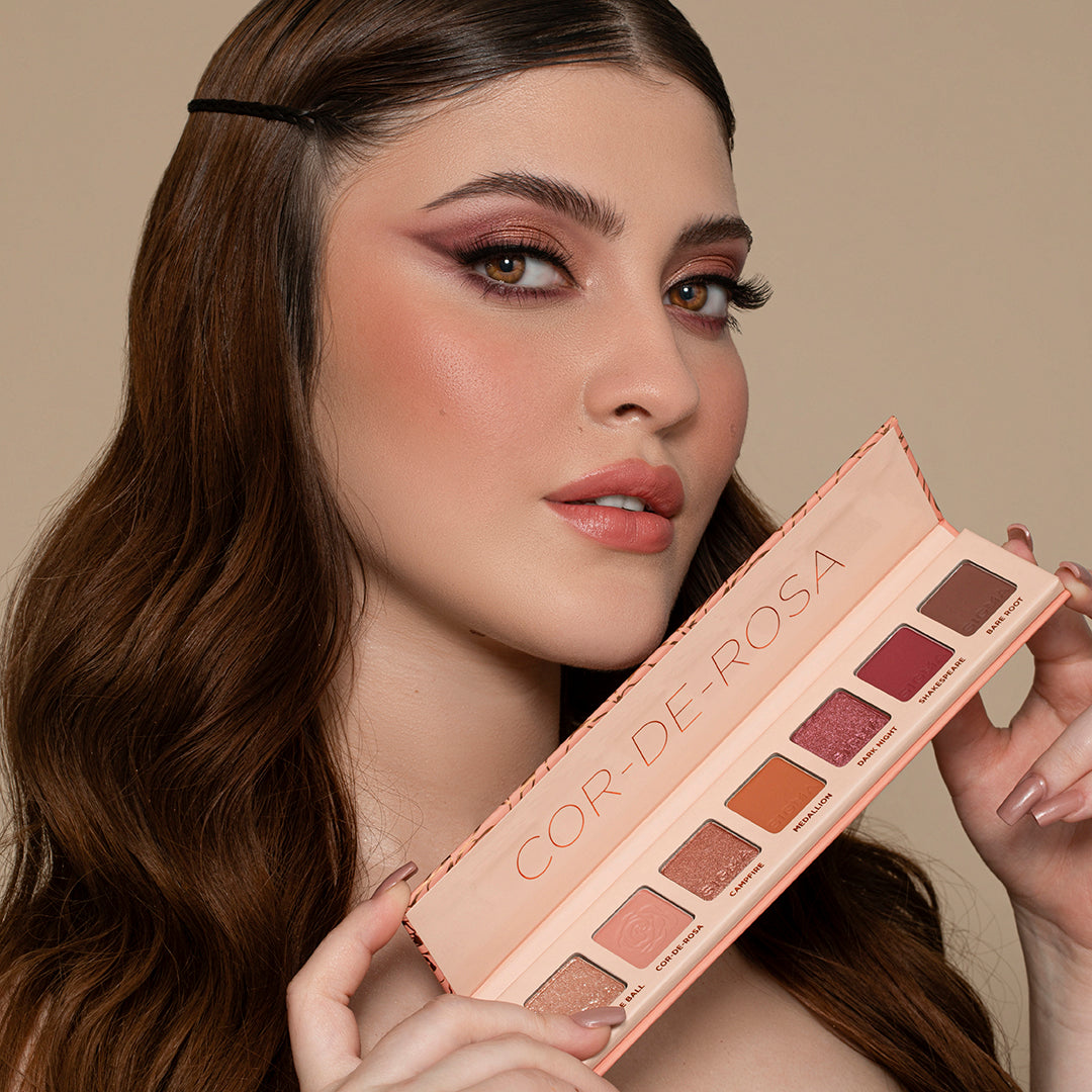 model holding Sigma Beauty Cor-de-Rosa Mini 7-Shade Eyeshadow Palette