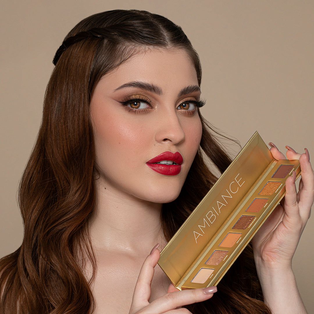 model holding Sigma Beauty Ambiance Mini 7-Shade Eyeshadow Palette