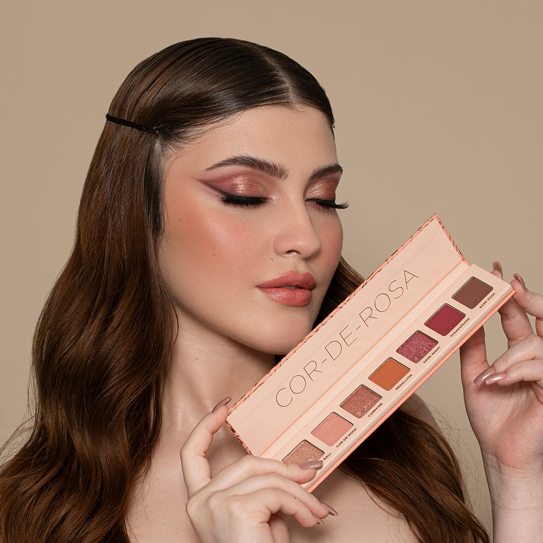 model holding Sigma Beauty Cor-de-Rosa Mini 7-Shade Eyeshadow Palette
